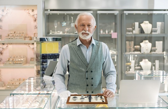 Senior man in jewelry store selling luxury watches